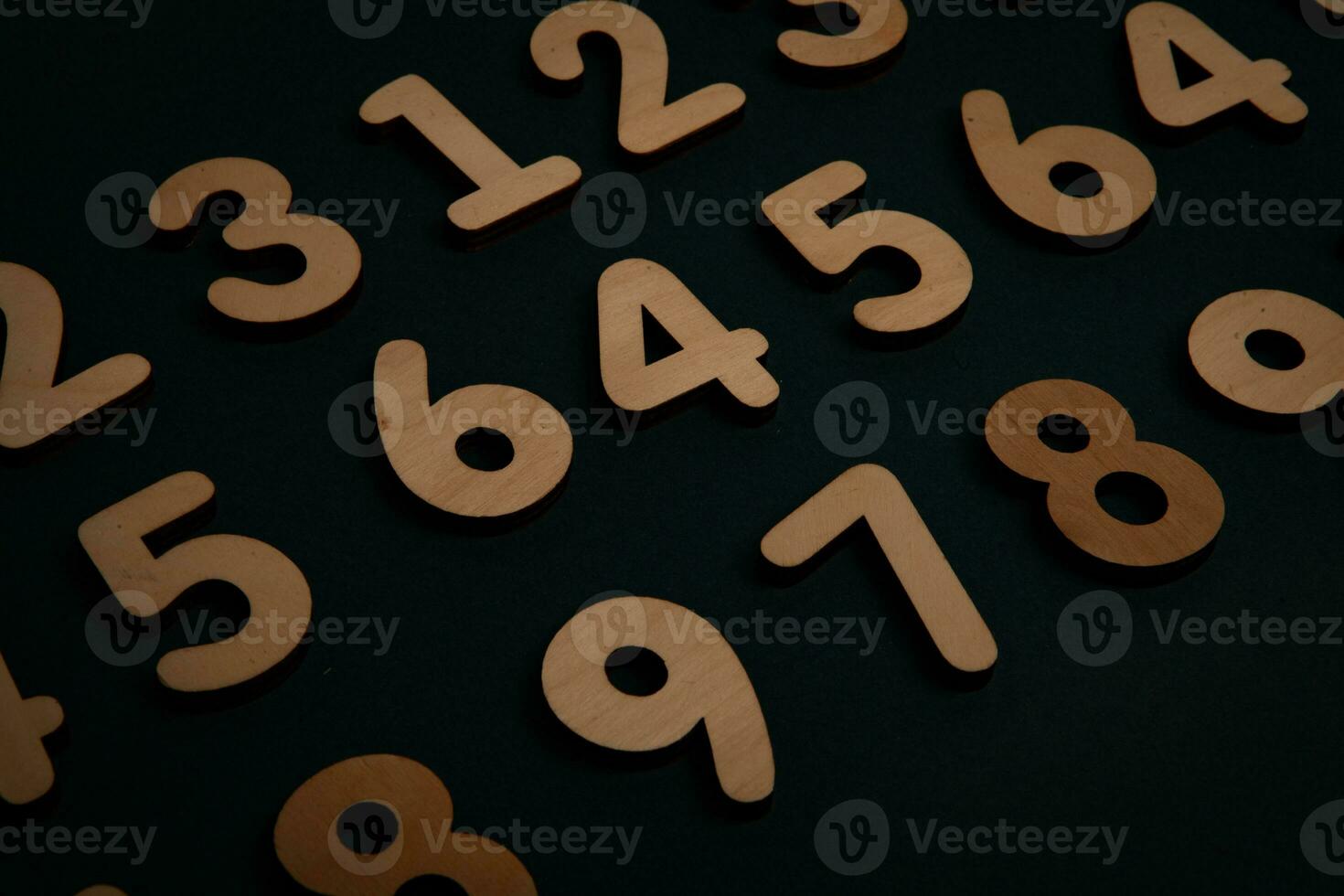 Wooden numbers on a black background. Numbers of different colors. photo