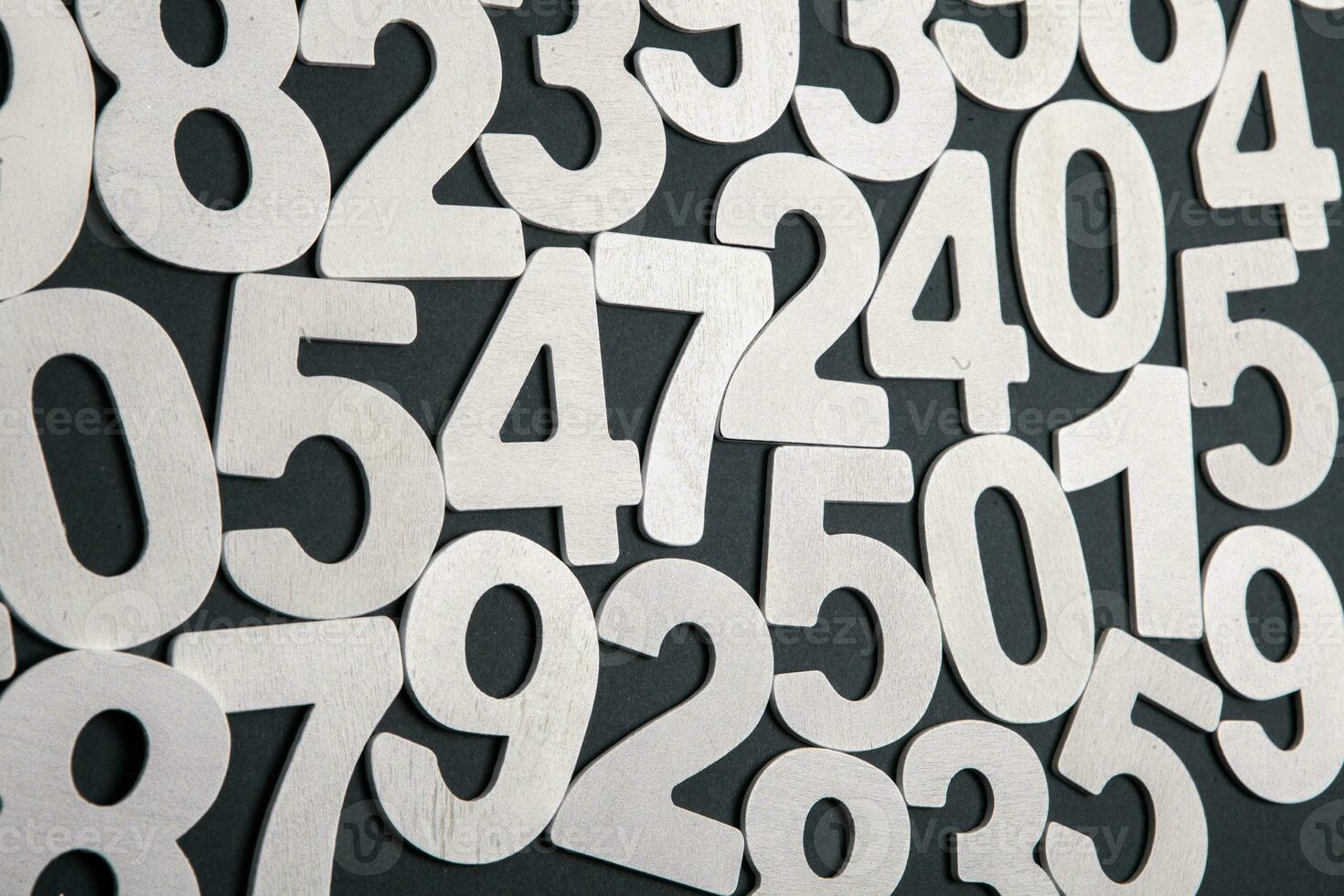 Wooden numbers on a black background. Numbers of different colors. photo