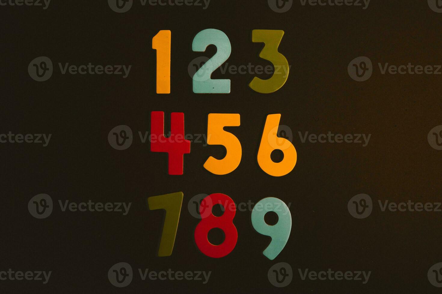 Colorful wooden numbers on black background. Number 1 to 9. photo