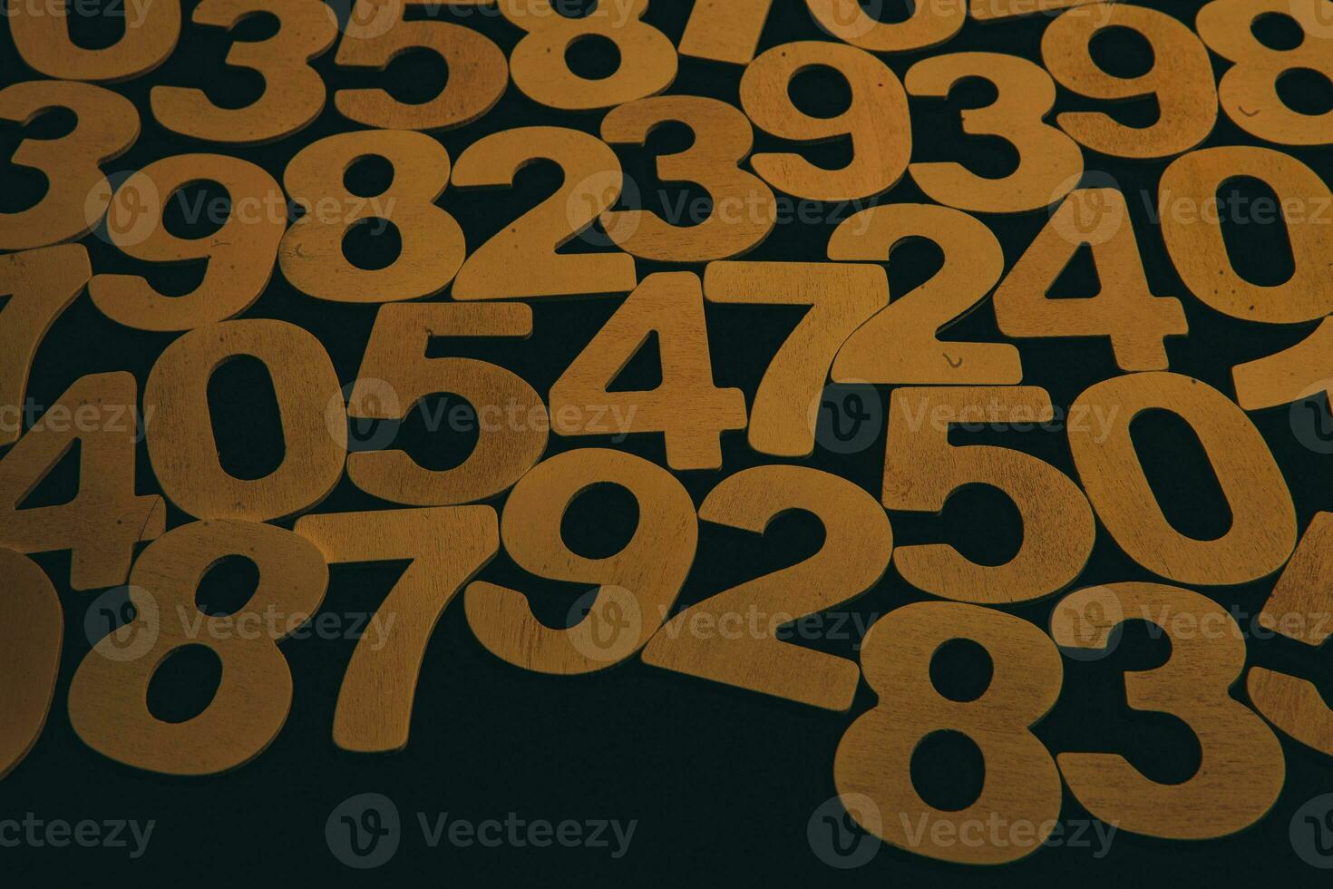 Wooden numbers on a black background. Numbers of different colors. photo