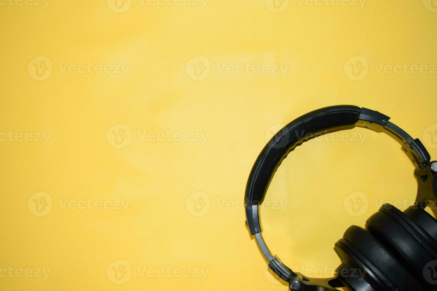 top view headphone with cable on yellow background with copy space photo