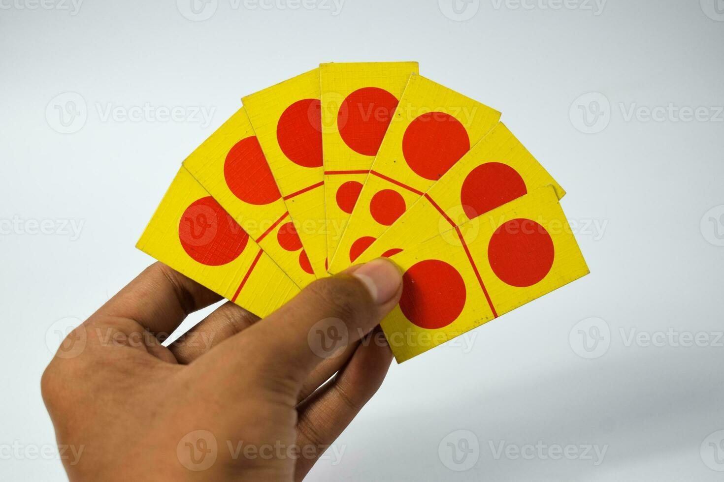 hand hold dominoes playing cards isolated white background, yellow red dominoes cards photo