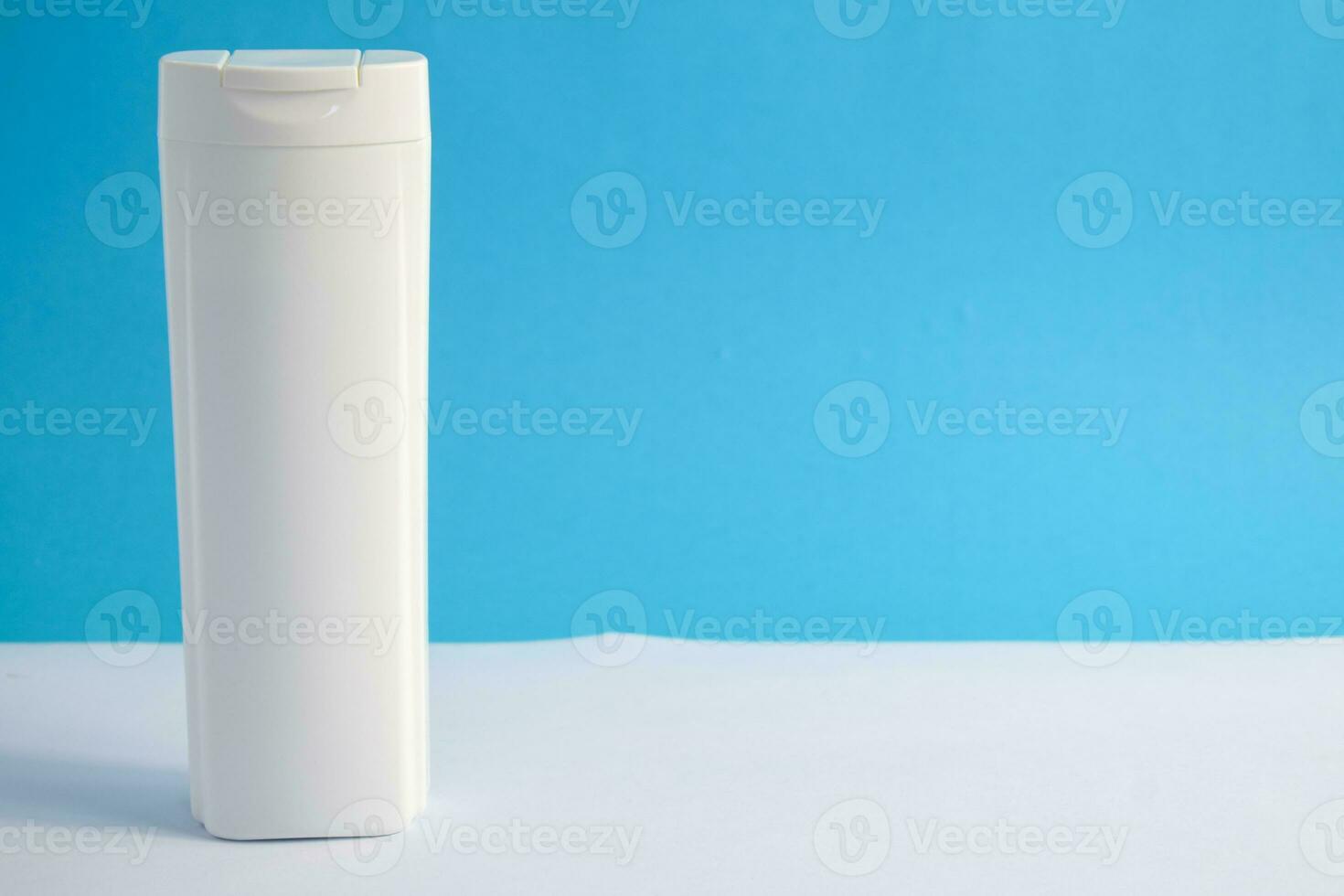 White Bottle shampoo blank for mock up with blue background, beauty health care mockup bottle. photo