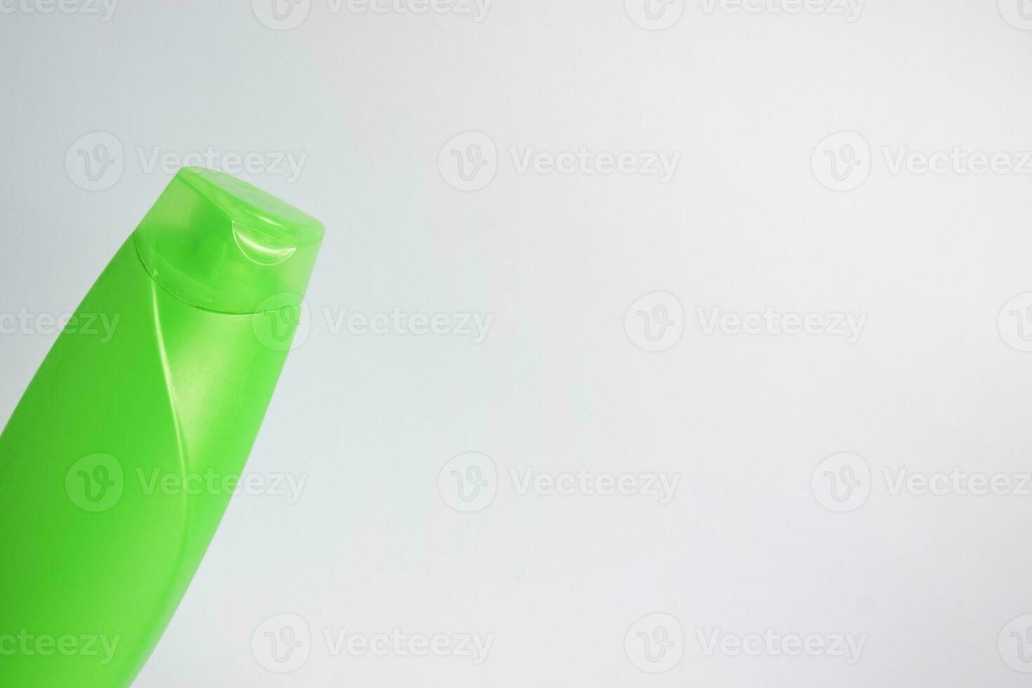 Green blank bottle shampoo minimalist bakcground, hair care bottle mock up product. photo