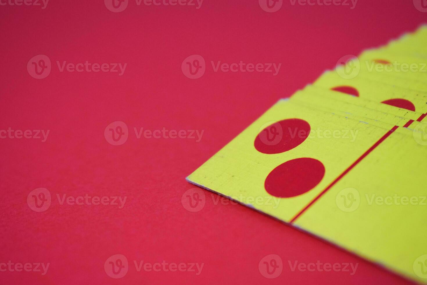 dominoes playing cards isolated red background, yellow red dominoes cards photo