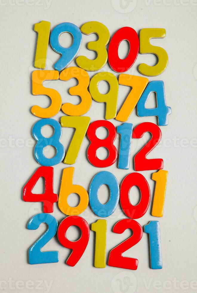 Colorful wooden numbers on a blackboard background with space for text photo