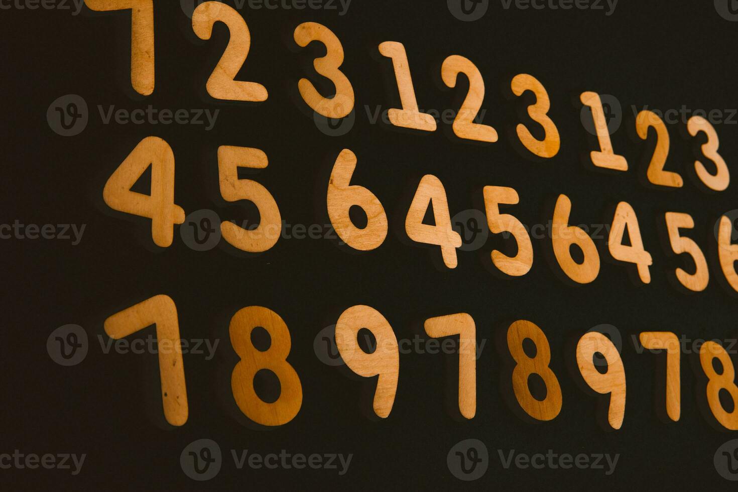 Colorful wooden numbers on a blackboard background with space for text photo
