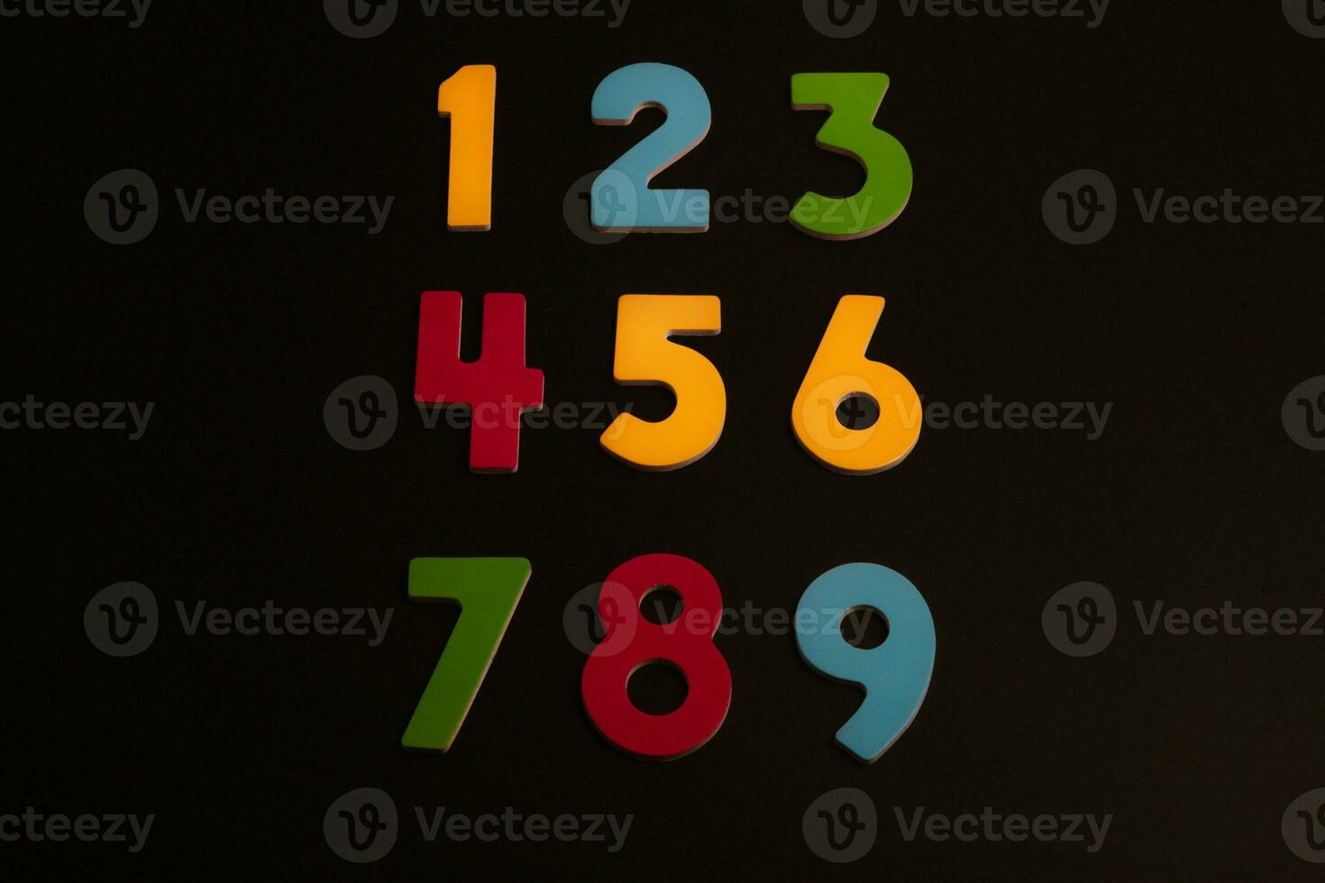 Colorful wooden numbers on black background. Number 1 to 9. photo