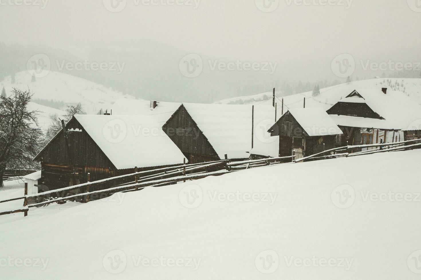 Panorama of the village in the winter mountains covered with snow. Winter landscape. The concept of freedom and solitude. photo