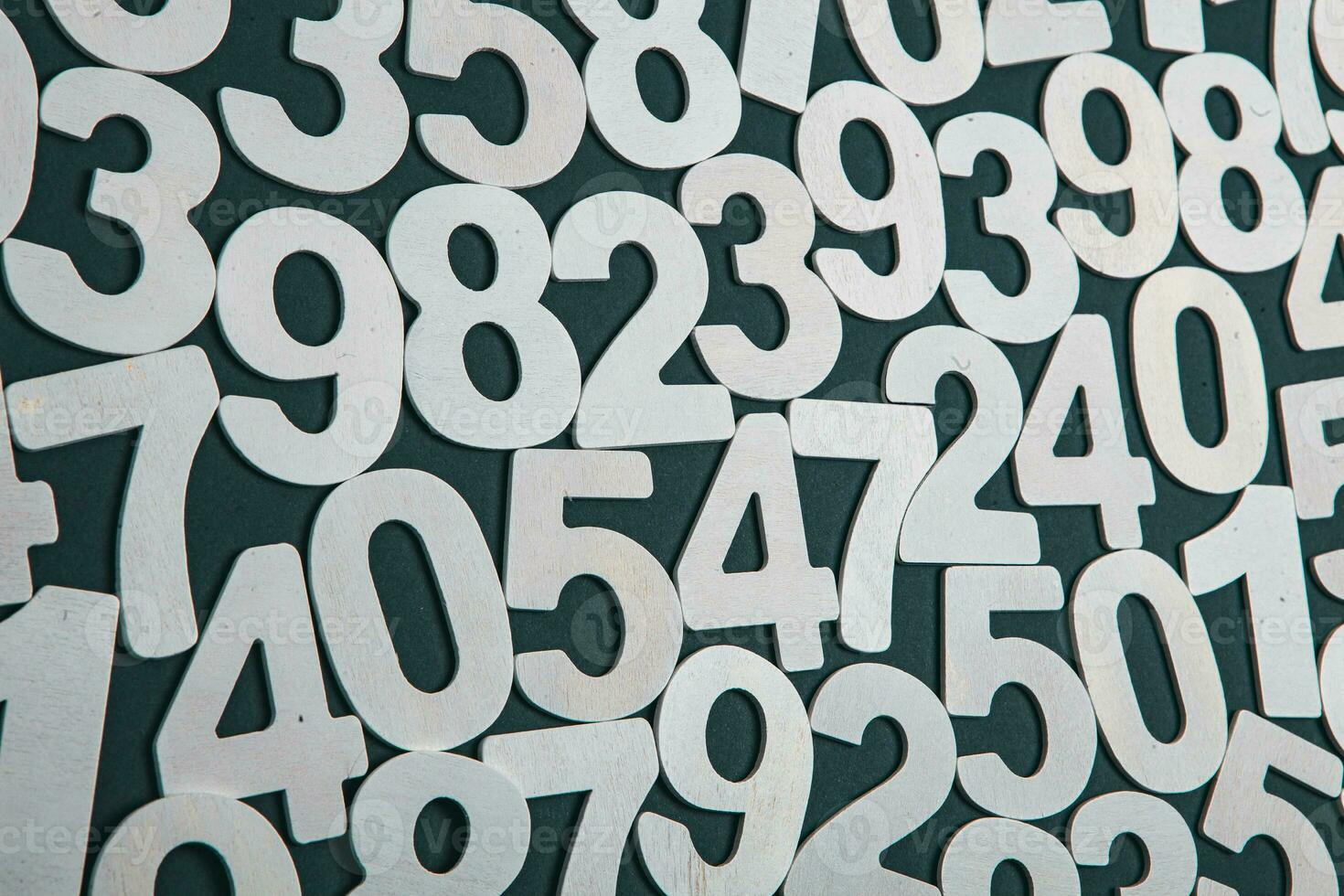 Wooden numbers on a black background. Numbers of different colors. photo