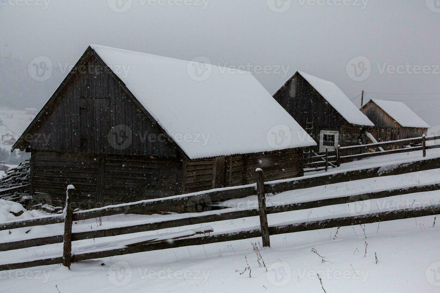 Panorama of the village in the winter mountains covered with snow. Winter landscape. The concept of freedom and solitude. photo