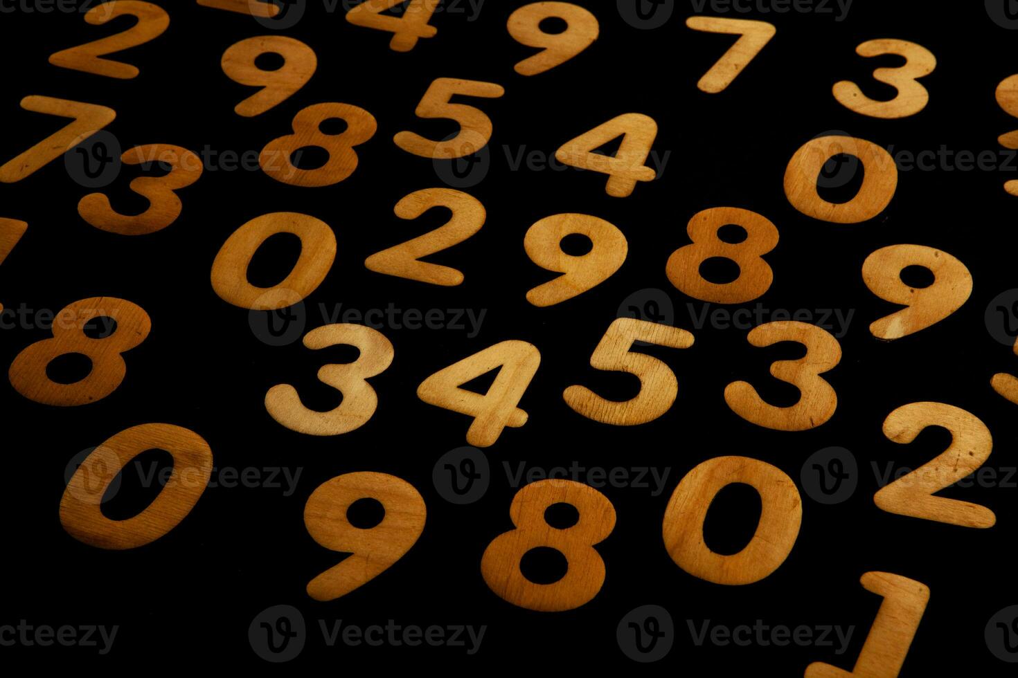 Wooden numbers on a black background. Numbers of different colors. photo