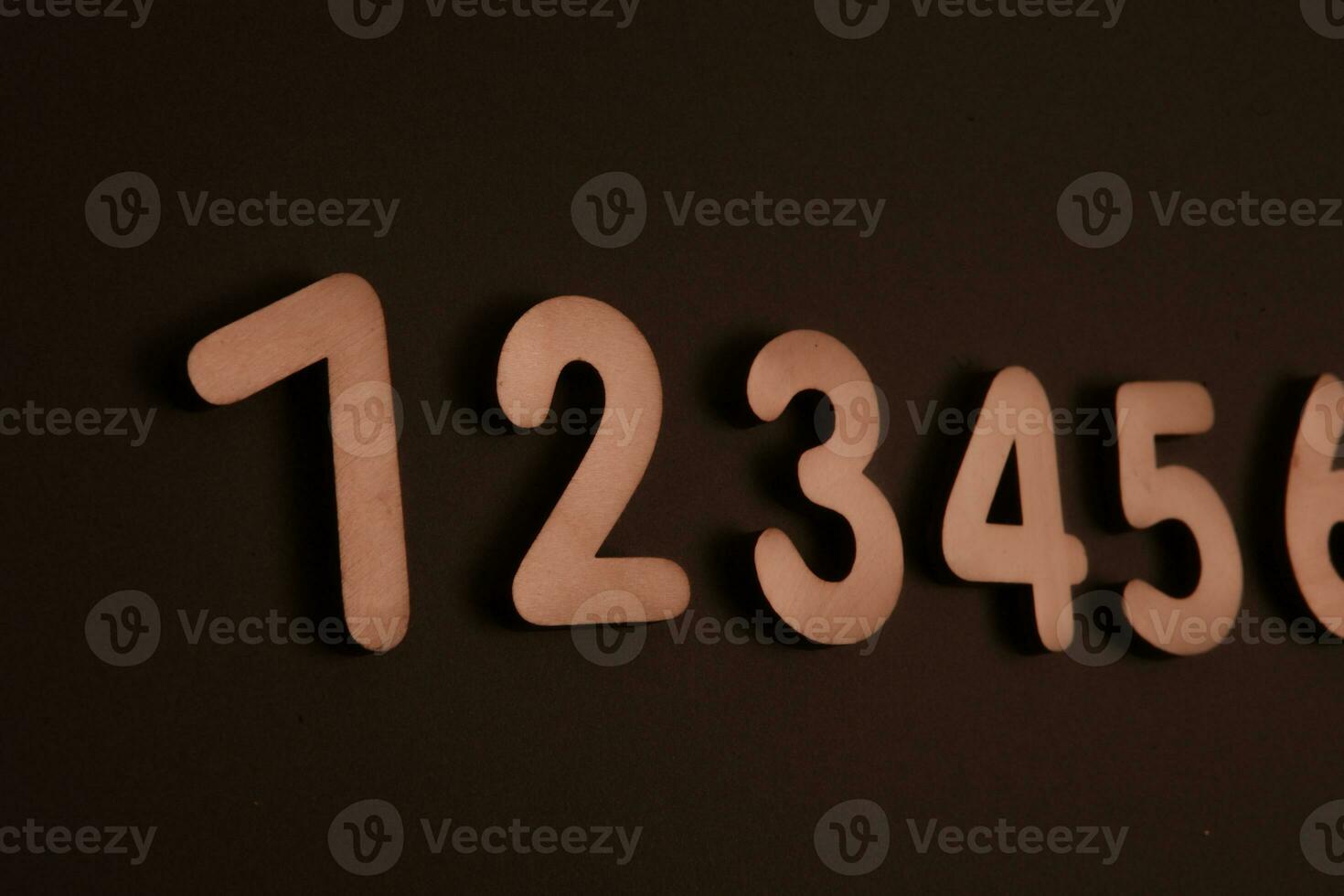 Colorful wooden numbers on black background. Number 1 to 9. photo