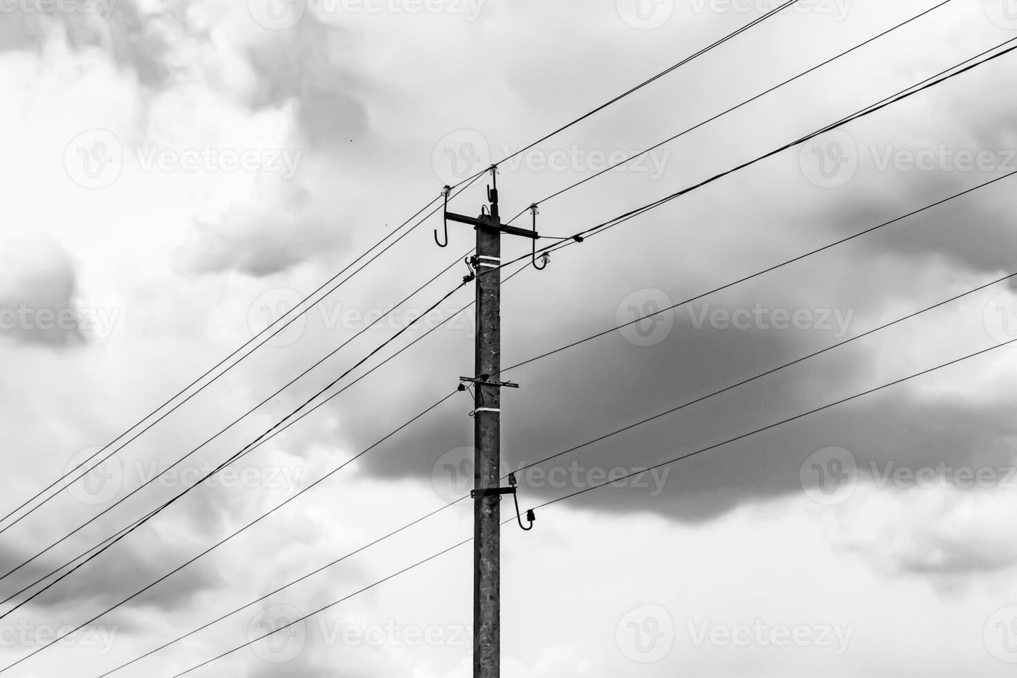 Power electric pole with line wire on light background close up photo