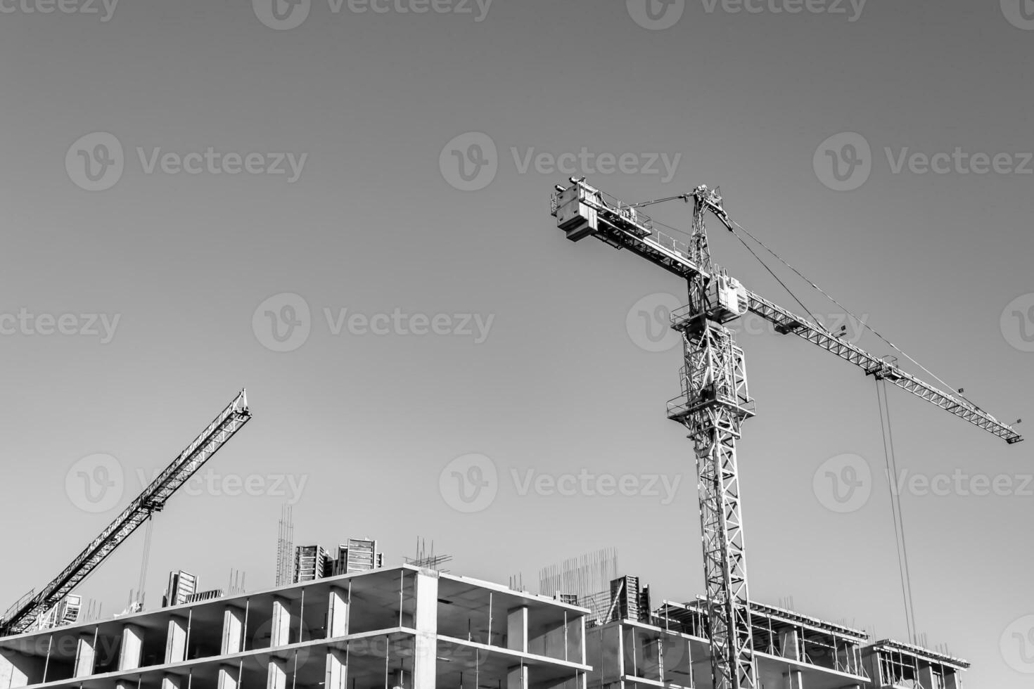 Big steel crane on construction site of residential building photo