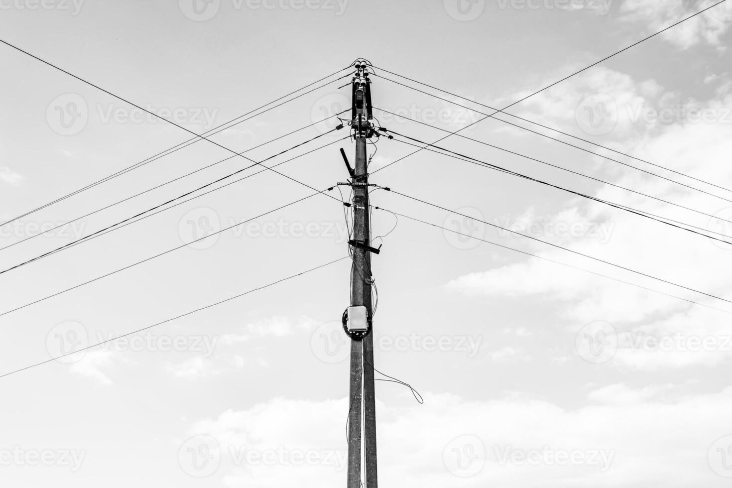 Power electric pole with line wire on dark background close up photo