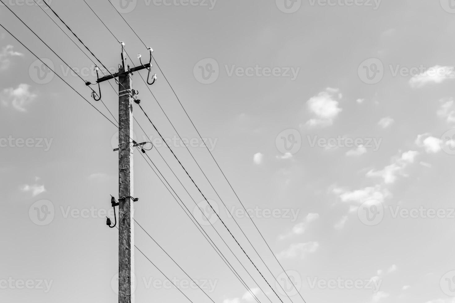 Power electric pole with line wire on light background close up photo