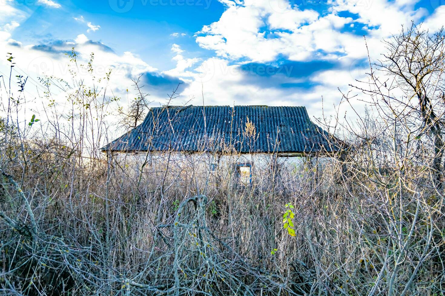 Beautiful old abandoned building farm house in countryside on natural background photo