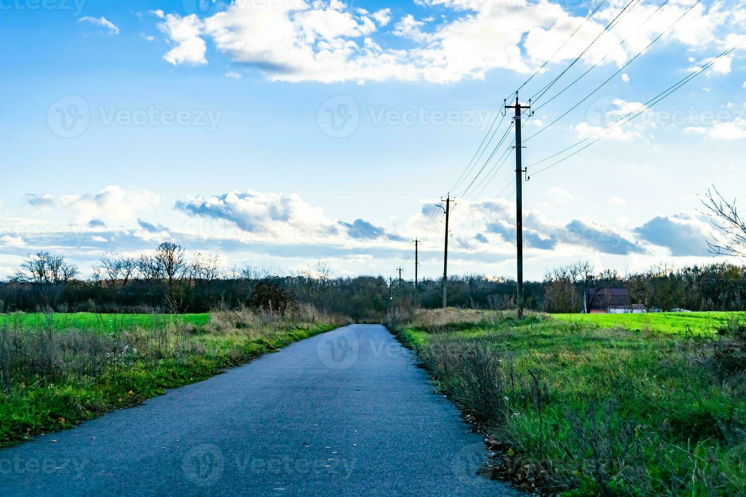 Beautiful empty asphalt road in countryside on colored background photo