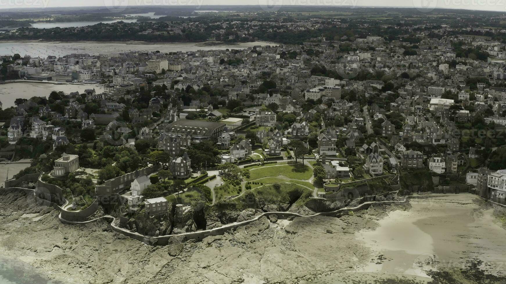Stunning aerial view of the coastal big city with white houses and cottages located near the beach. Action. Modern city with beautiful architecture and the ocean shore. photo