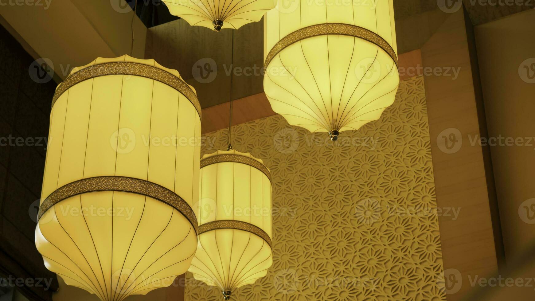Yellow, orange paper lamp traditional lanna style. Traditional Nepalese, Chenese or Asian lamp under the ceiling photo