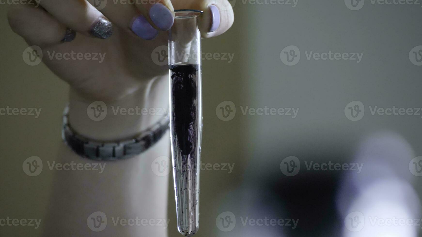 Laboratory tests with test tube and small pipette filled with black liquid, water contamination, experiment. Black liquid in a test tube photo