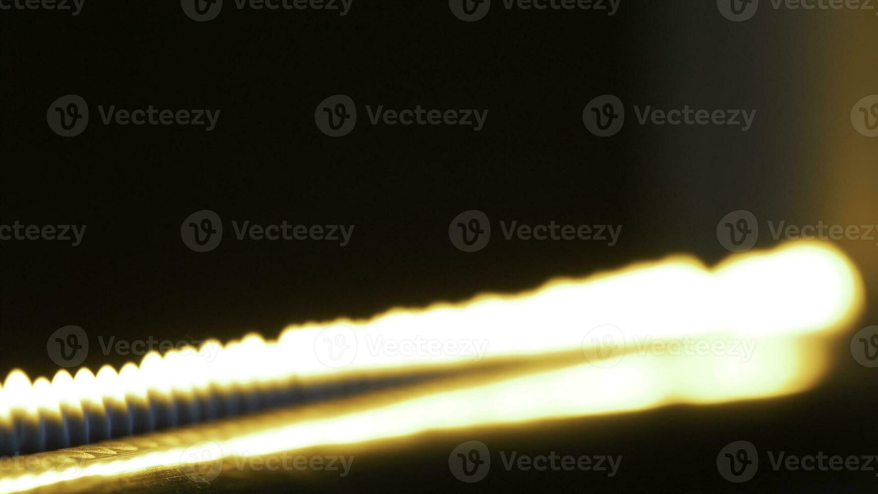 Pipe with fire in the chemistry laboratory close up. Gas system in the lab. Musical instrument with flames. Tube and fire close up photo