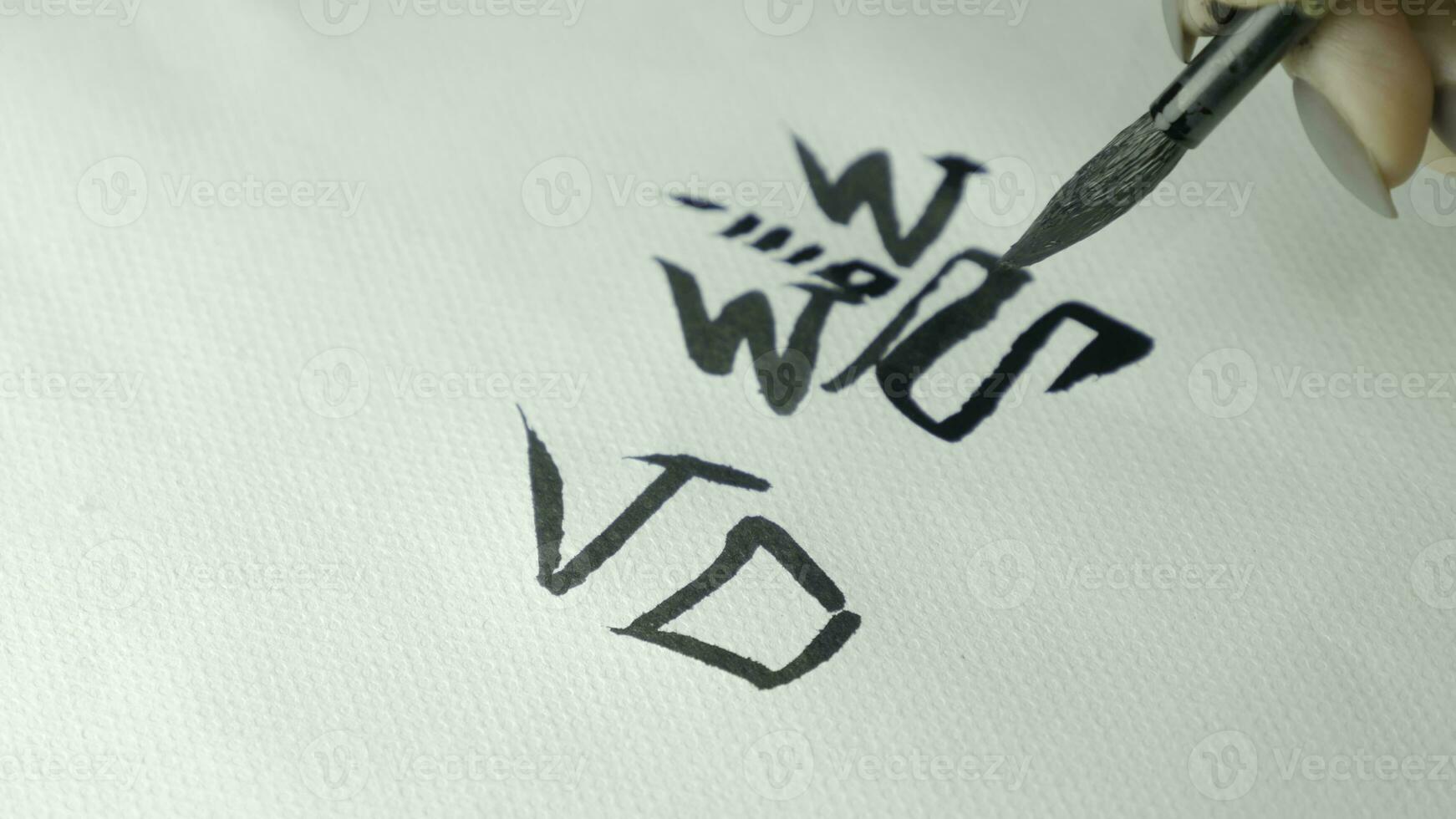 Woman's hands writing Chinese hieroglyph. Female hand holding a writing brush calligraphy Chinese characters, close up photo