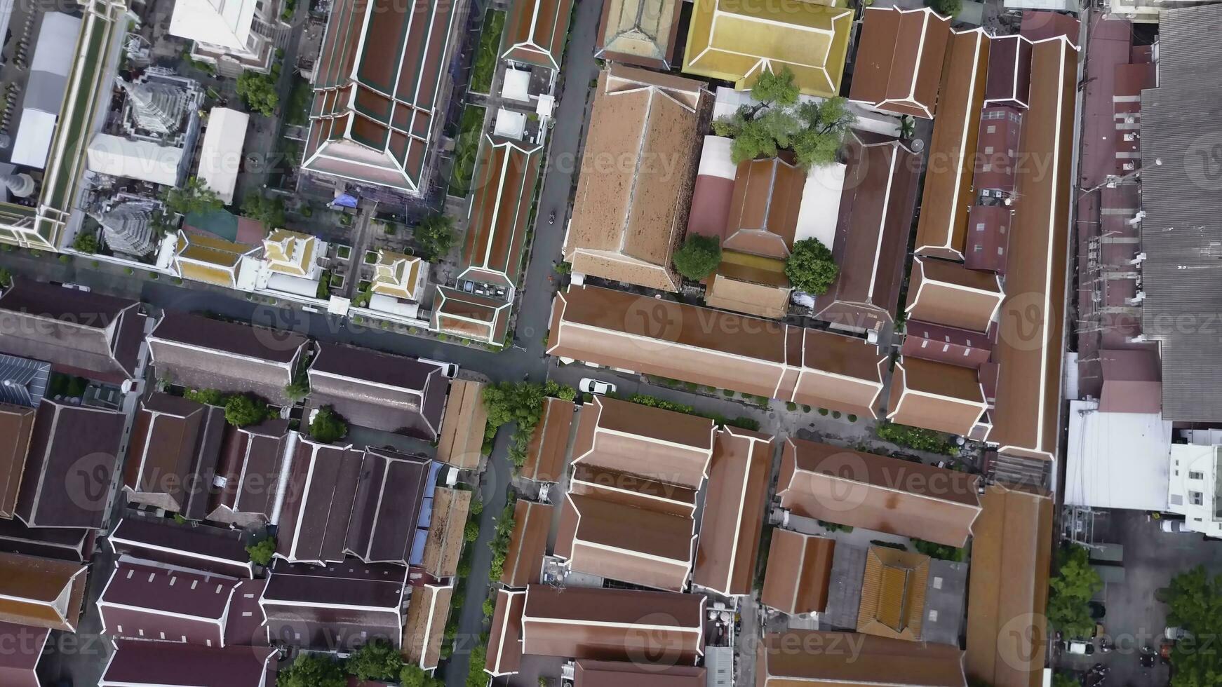 Nice view from the top of houses with tiled roofs. Top view of modern and old houses of the city. Cityscape of town and city from top view. Old and modern architecture of different styles. Authentic photo