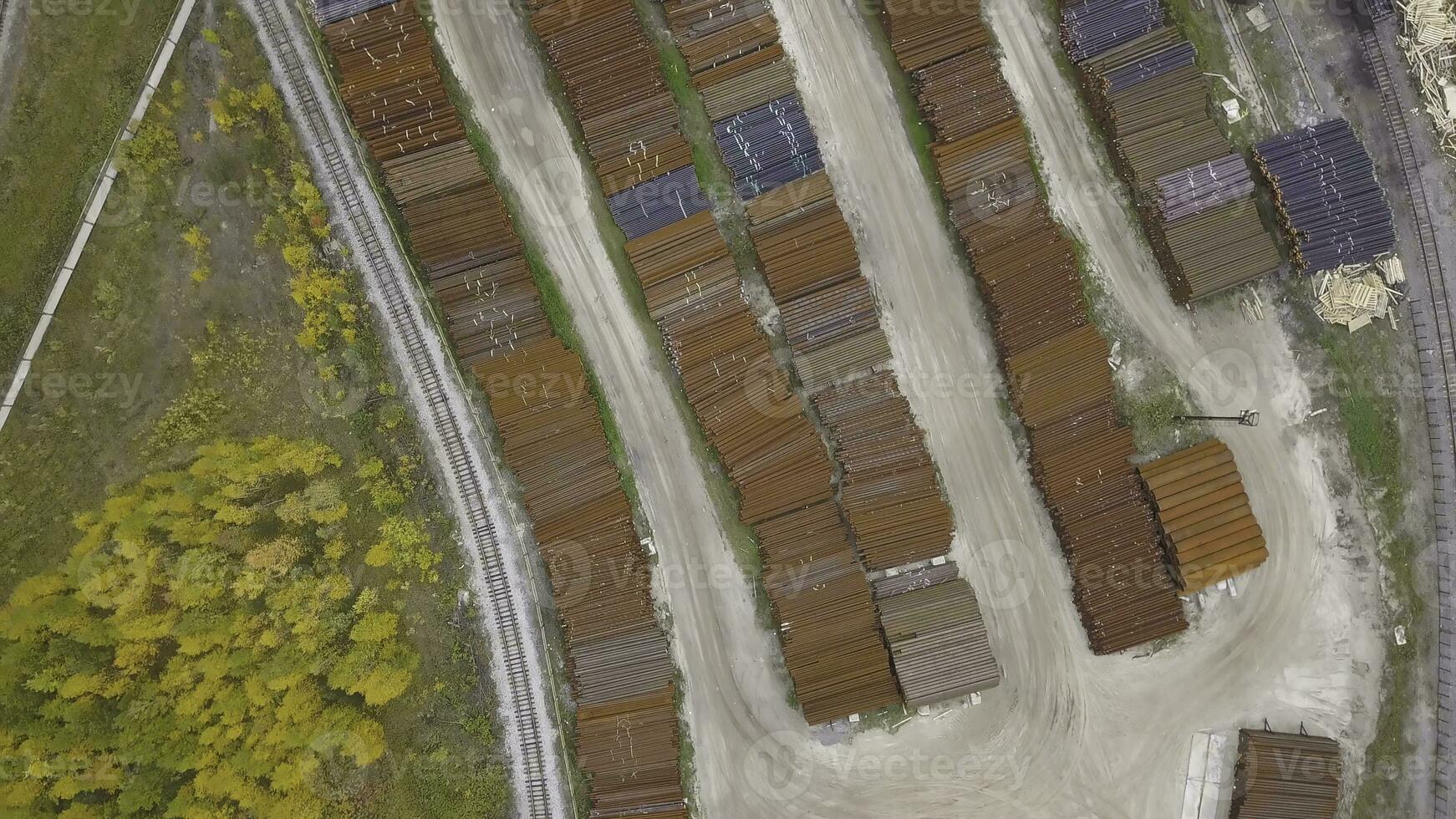 Top view of the industrial area located near the yellow forest, autumn nature. Clip. Aerial view of warehouses and the road near industrial zone. photo