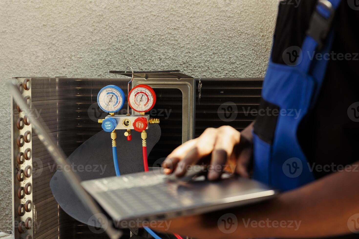 Certified technician hired by home owner to detect cause of damage to air conditioner, writing down superheat and subcooling values measured by professional manifold meters photo