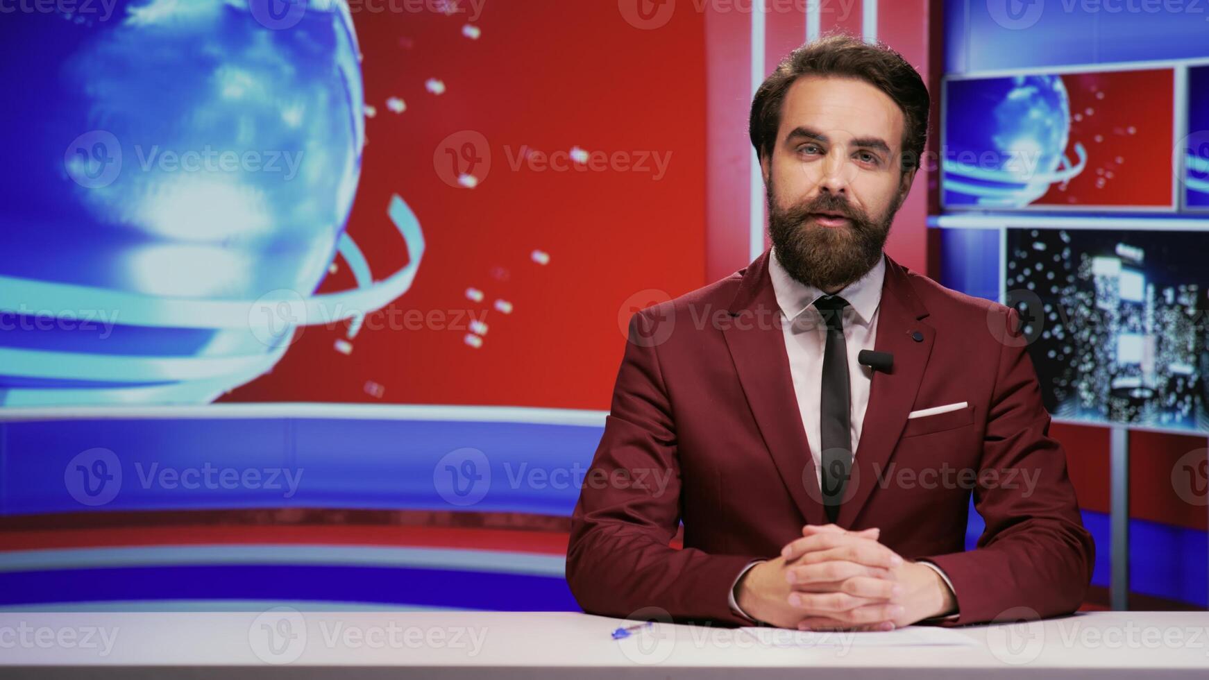 News anchor addressing important topics live on television program, hosting media breaking news segment in newsroom. Man reporter doing newscast on tv network, global communications. photo