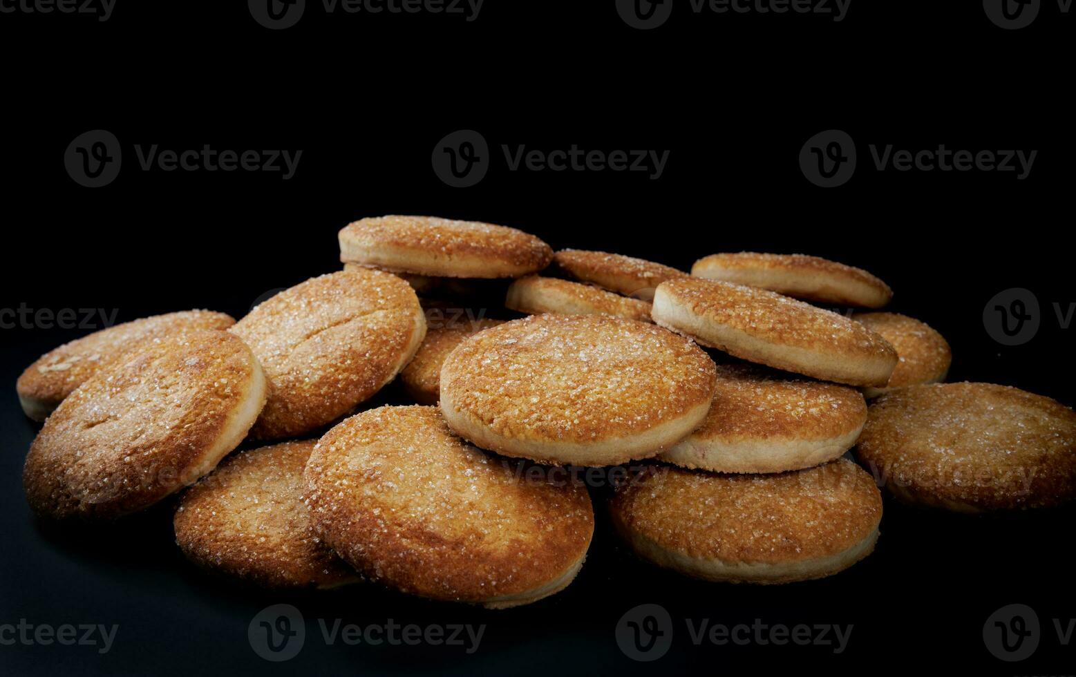 Beautiful round cookies on a black background. A few cookies. A bunch of cookies. photo