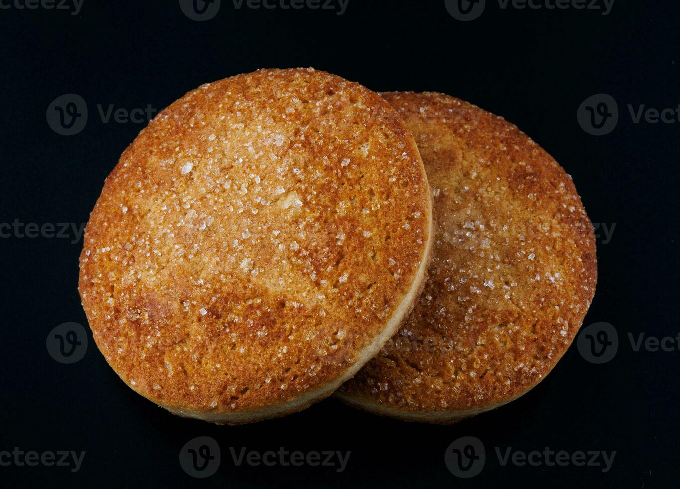 eautiful round cookies on a black background. A few cookies. Two cookies. photo