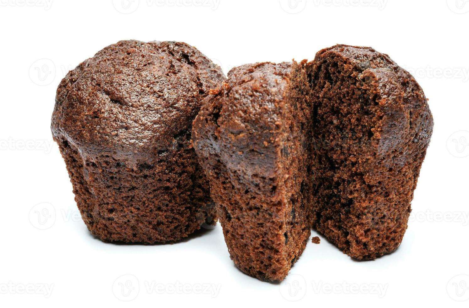 Whole and cut in half chocolate muffin isolated on white background. Chocolate chip muffin. photo