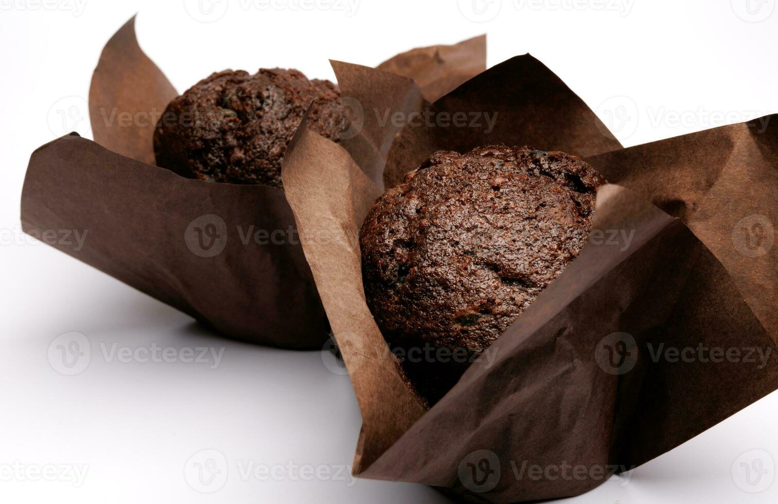 Two chocolate muffins on a white background . Muffin with chocolate chips. photo