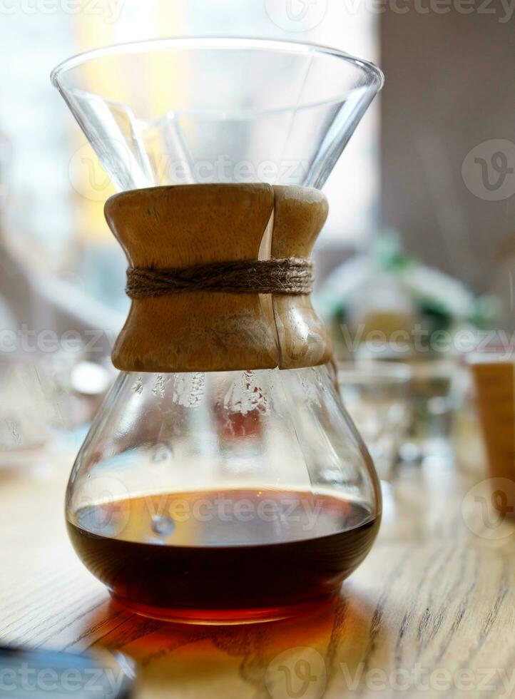 Fresh black coffee in a glass infuser. photo