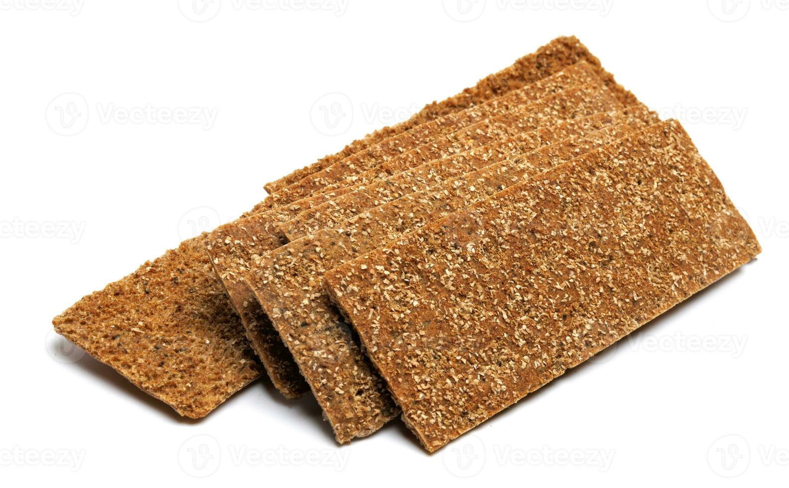 Slices of healthy low calories grain crisp bread for snack and crumbs on white background. Top view. photo