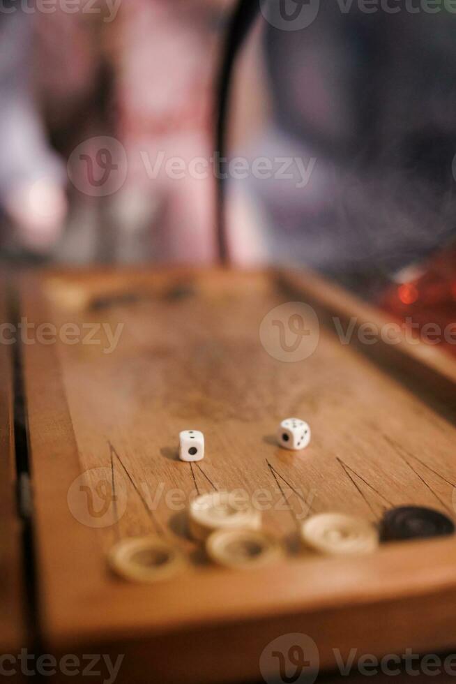 Dice lie on a backgammon board. photo