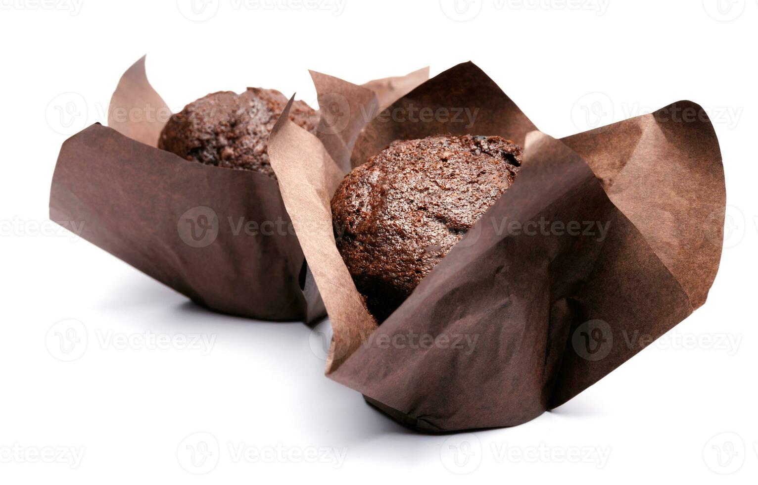 Two chocolate muffins isolated on a white background . Muffin with chocolate chips. photo