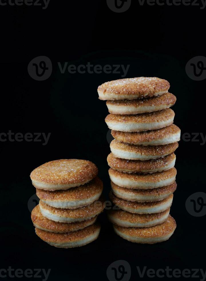 hermosa redondo galletas en un negro antecedentes. un pocos galletas. dos Galleta torres foto