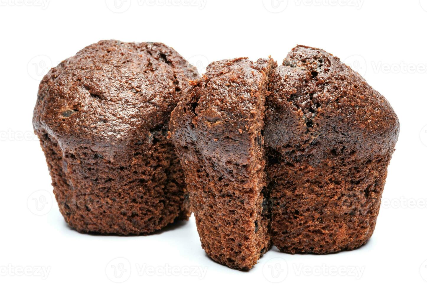 Whole and cut in half chocolate muffin isolated on white background. Chocolate chip muffin. photo