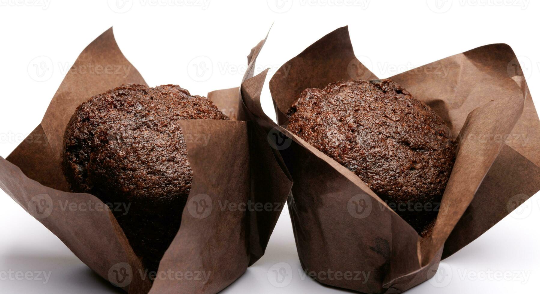 Two chocolate muffins on a white background . Muffin with chocolate chips. photo