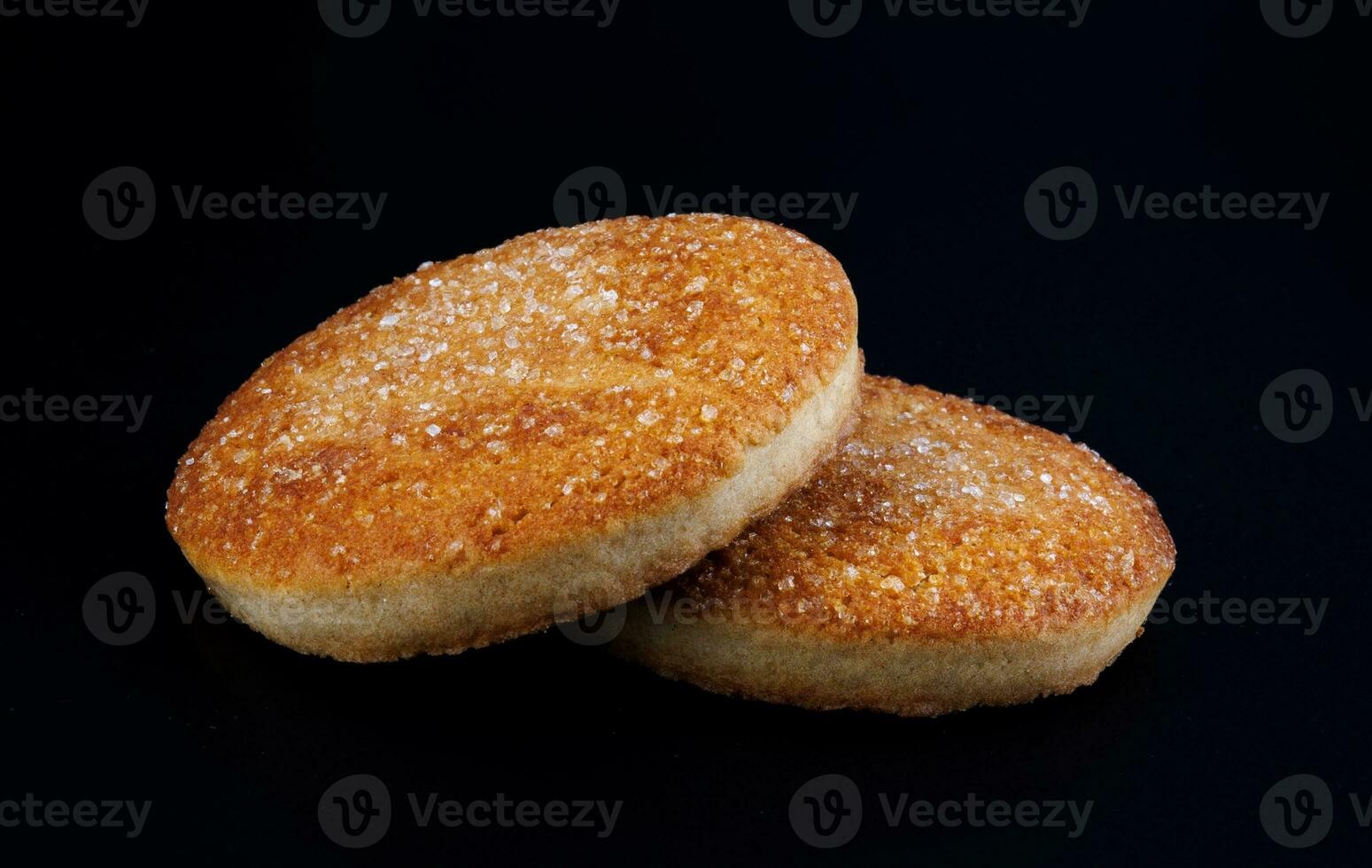 eautiful round cookies on a black background. A few cookies. Two cookies. photo