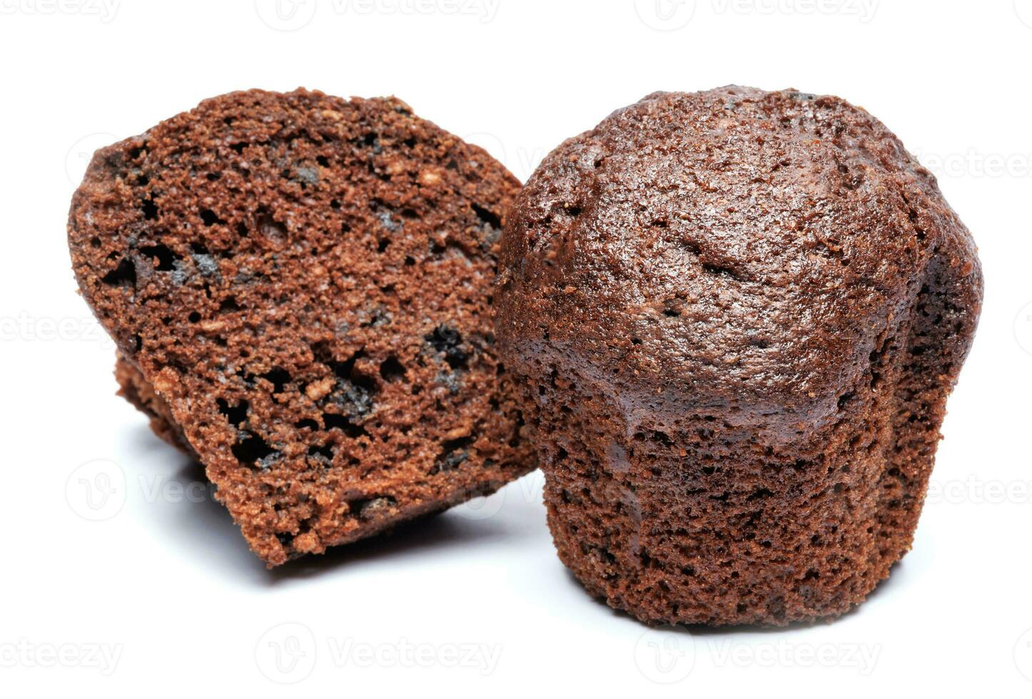 Whole and cut in half chocolate muffin isolated on white background. Chocolate chip muffin. photo