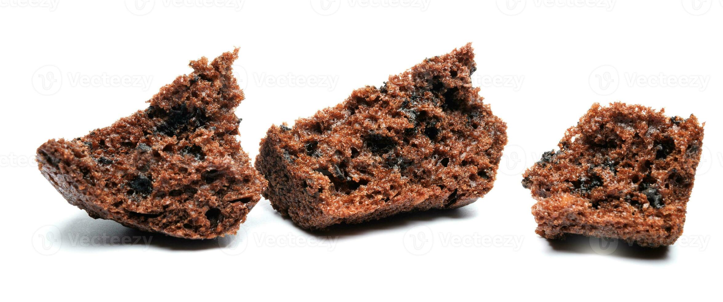 Chocolate muffin broken into pieces isolated on a white background. Chocolate chip muffin. photo