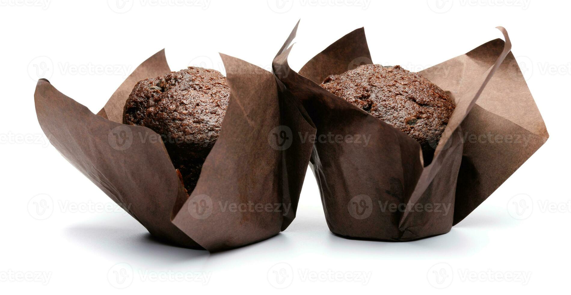 Two chocolate muffins isolated on a white background . Muffin with chocolate chips. photo