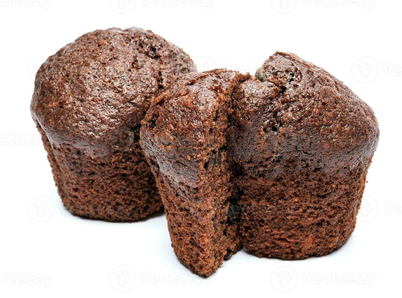 Whole and cut in half chocolate muffin isolated on white background. Chocolate chip muffin. photo