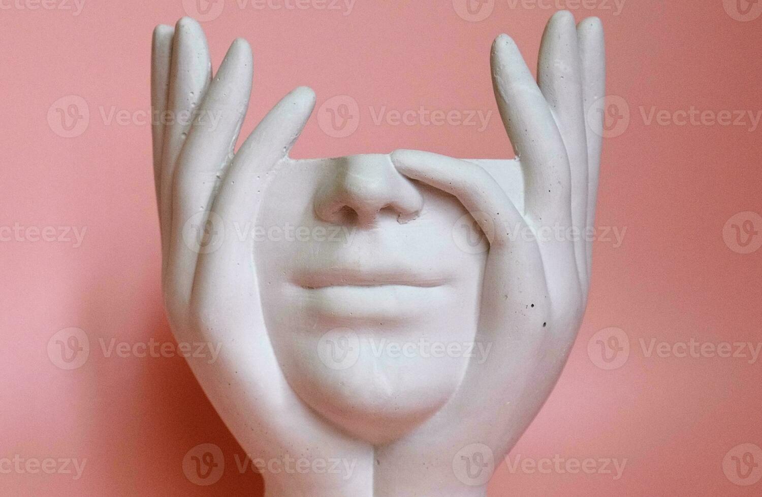 on a pink background, a white plaster figurine without a head photo