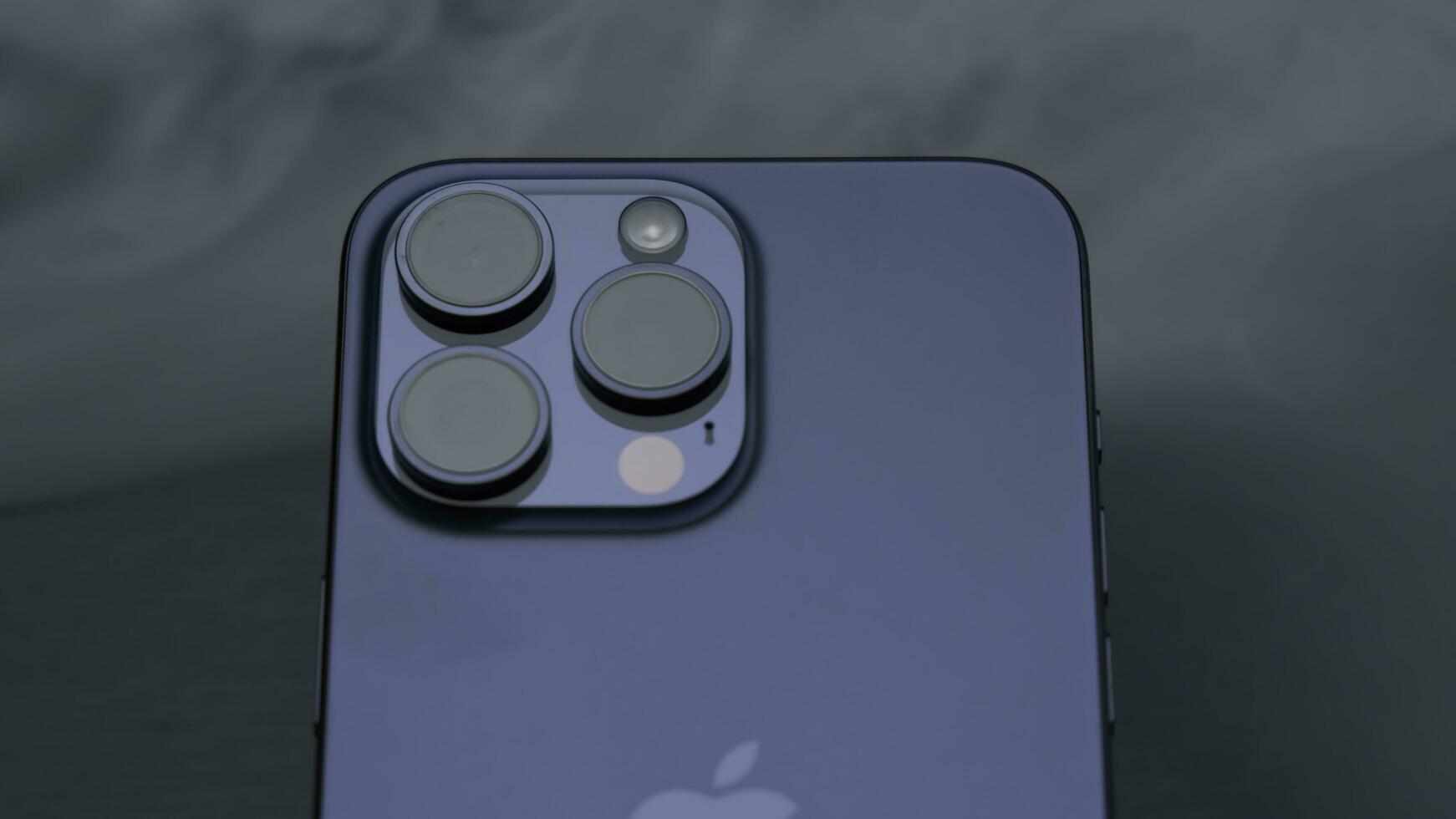 USA, New York - September 15, 2023. Close-up of stylish model of new iPhone. Action. Stylish design of new iPhone 15 pro on background of smoke. Promotional video of new iPhone model 15 pro photo